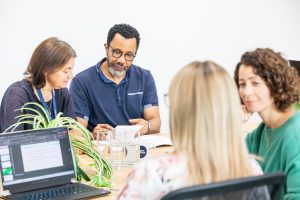 group of team mates discuss their charity data integrations objectives 