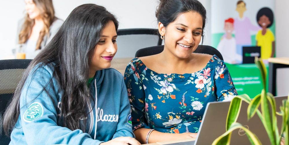 Two people working together on laptop